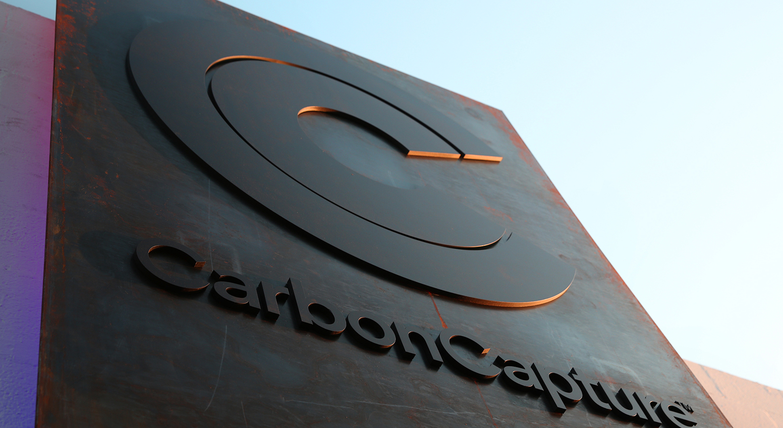 CarbonCapture Inc. signage showing the company logo mounted on a dark metal panel